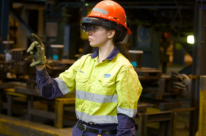 Female cadet using Hololens Mixed Reality glasses in a manufacturing facility